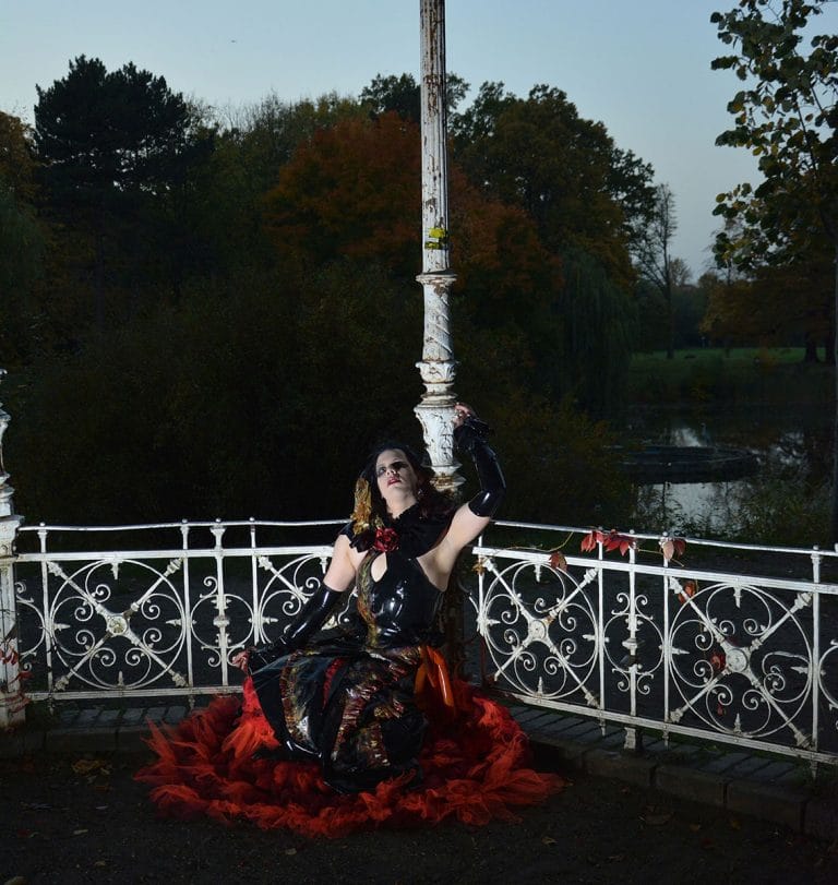 model showing a once in a lifetime by se'tyo latex dress in fire colors