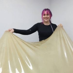 yuki while pulling a latex sheet in the atelier
