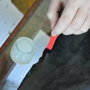 attaching glue with a spatula on a latex item