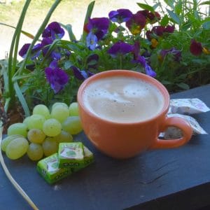 cup of coffee, fruits and flowers
