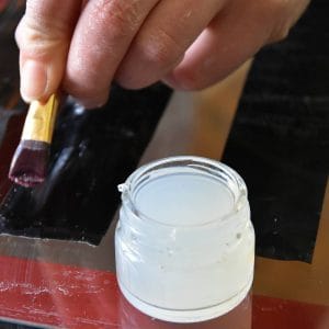 attaching glue onto latex with a brush