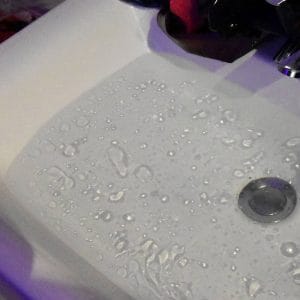 oil drops swimming on a filled sink