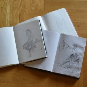 opened books with sketches