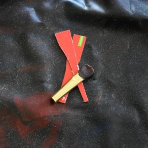 a glue spatula and a brush on a latex sheet