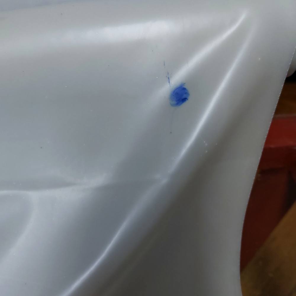 blue dot on a grey latex sheet